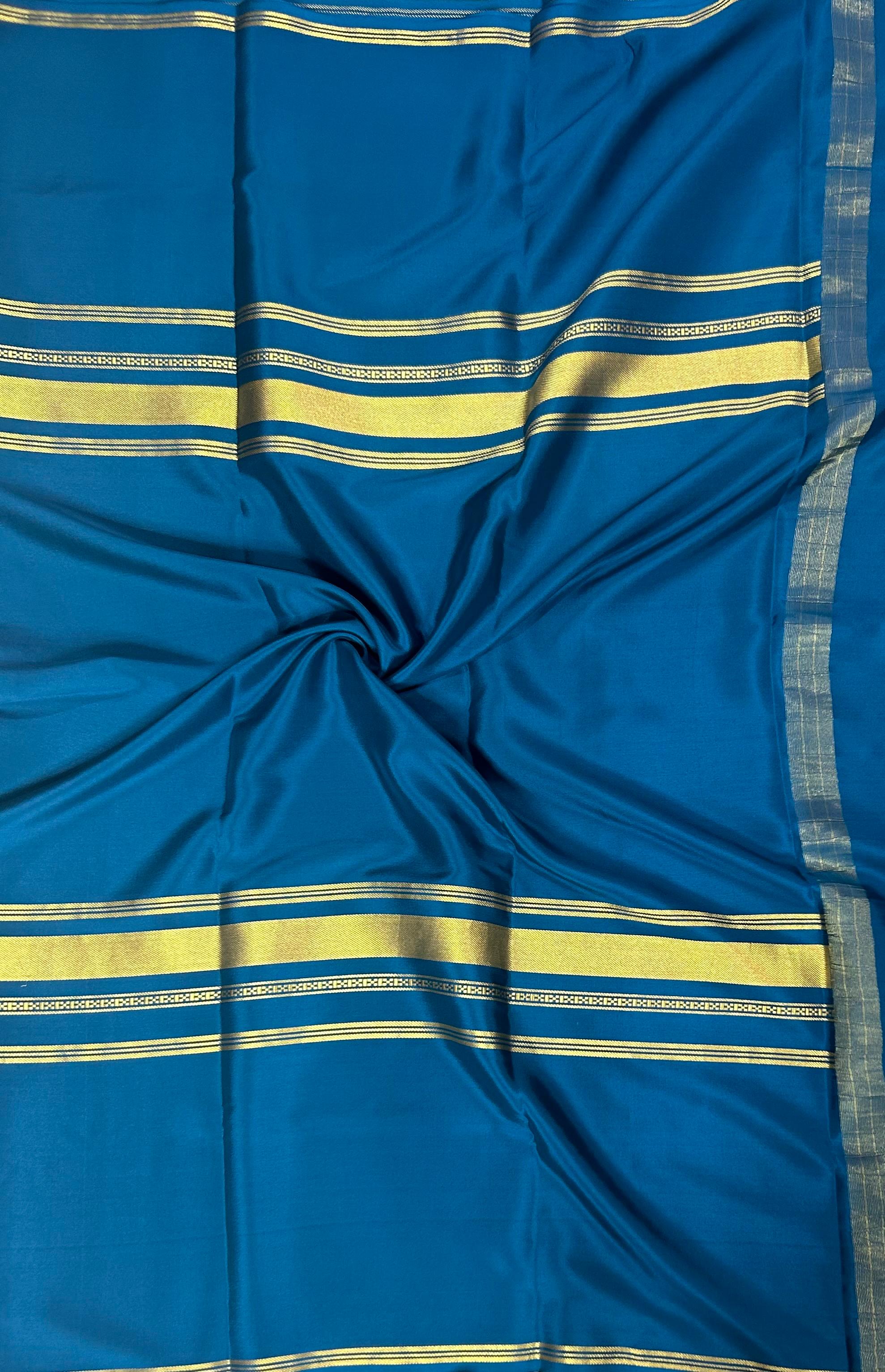 Peacock blue plain four border pure mysore crepe silk saree