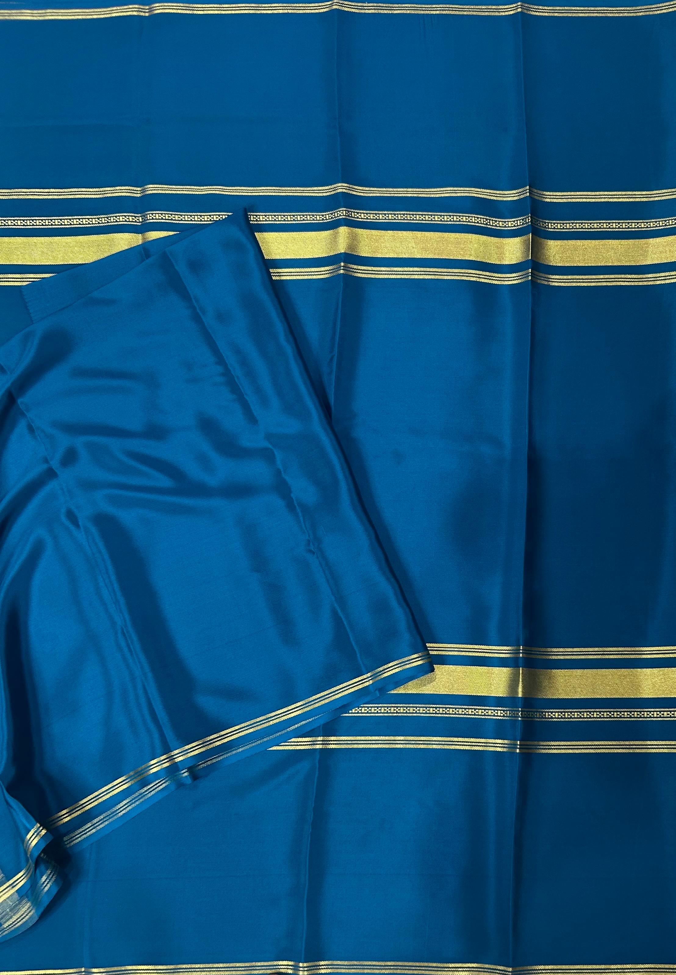 Peacock blue plain four border pure mysore crepe silk saree